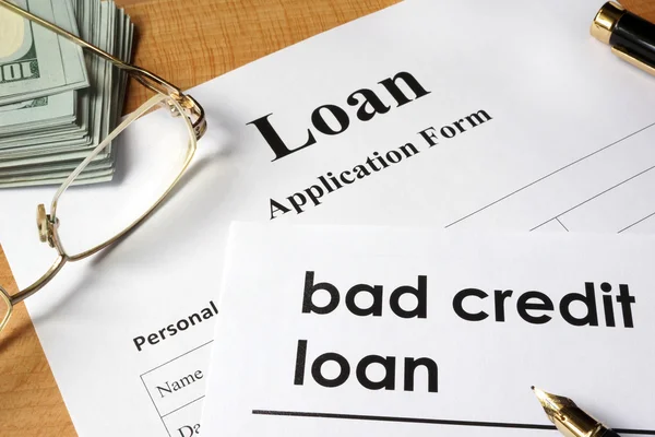 Page of Bad credit loan and application form on a table.