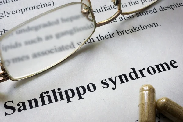 Paper with words Sanfilippo syndrome  and glasses. Medical concept.