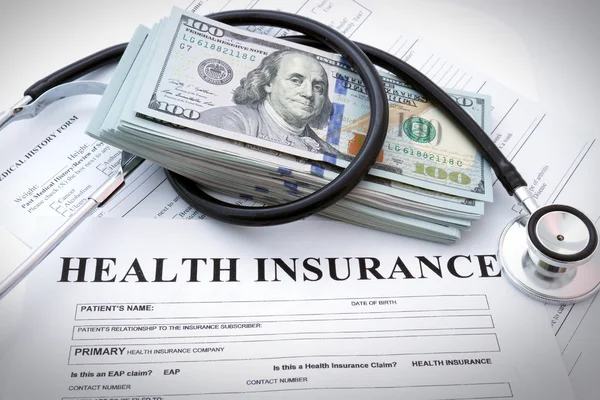 Health insurance form with money and stethoscope