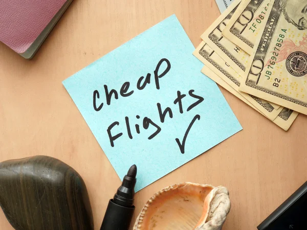 Cheap Flights paper on a table with money