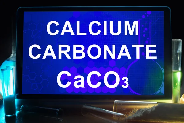 Tablet with chemical formula of  calcium carbonate.