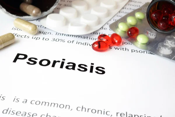 Paper with psoriasis  and pills.