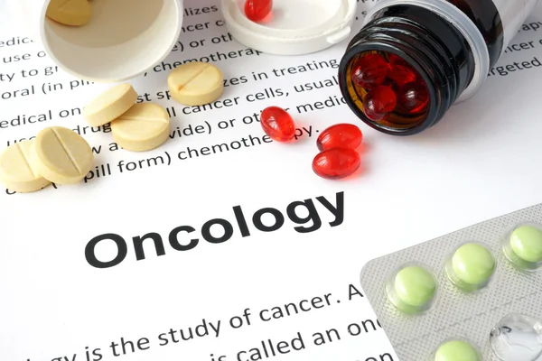 Paper with Oncology  and pills.