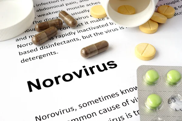 Paper with norovirus and pills.