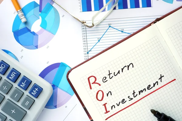 Notepad with words ROI return on investment  concept.