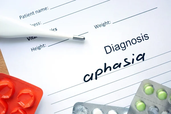 Diagnostic form with diagnosis Aphasia and pills.