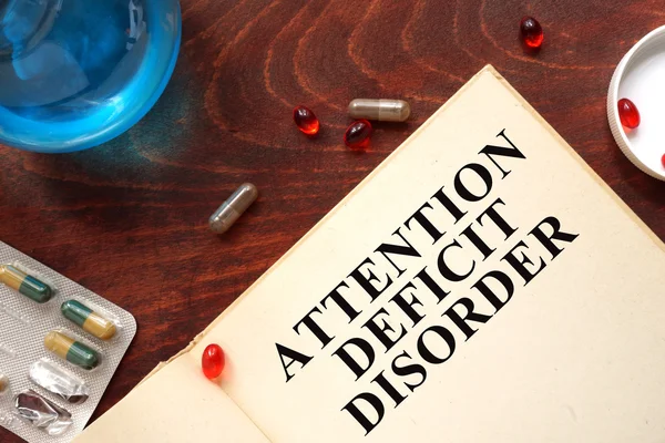 Attention deficit disorder  written on a book and diagnosis form.
