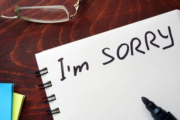 I am sorry written on notepad on a table.