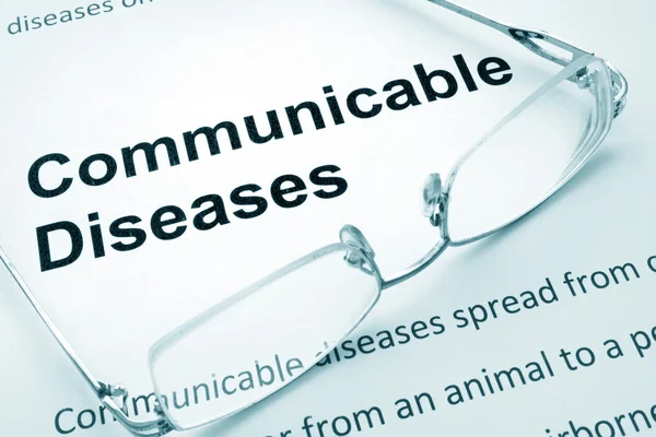 Paper with words communicable diseases and glasses.