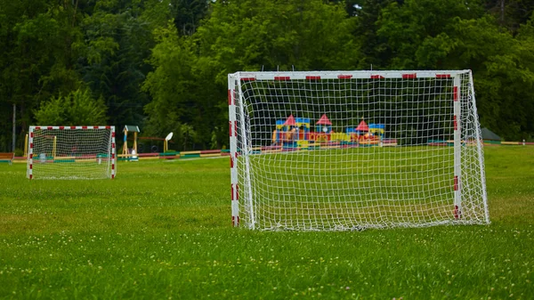 View of a net on vacant soccer pitch.