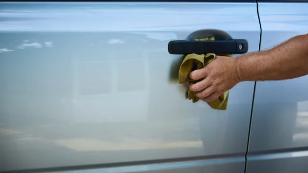 Close-up Of Hand With green Brush Washing Car