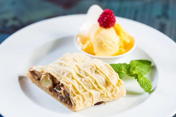 Apple strudel with icing sugar,almonds and vanilla ice cream