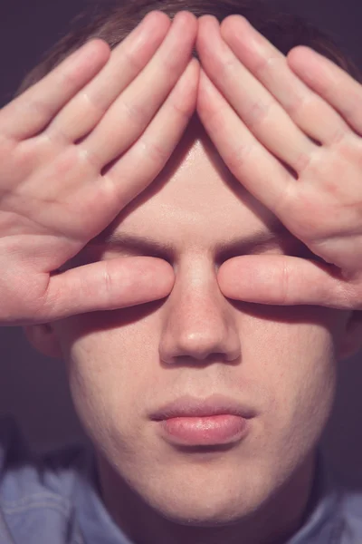 Man covering face with his both hands