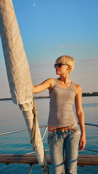 Woman traveling by boat at sunset
