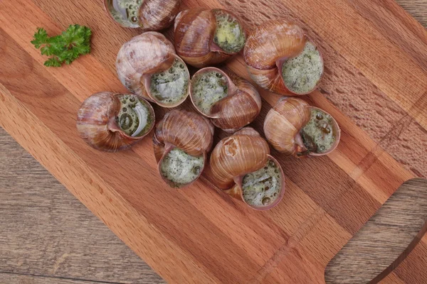 Snails with garlic, butter as french gastronomy gourmet food.