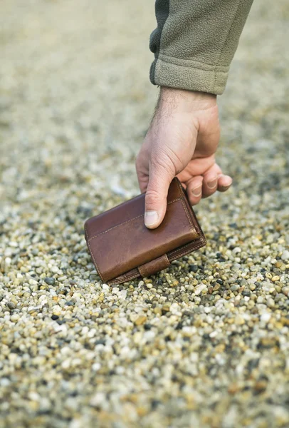 Man picking up wallet