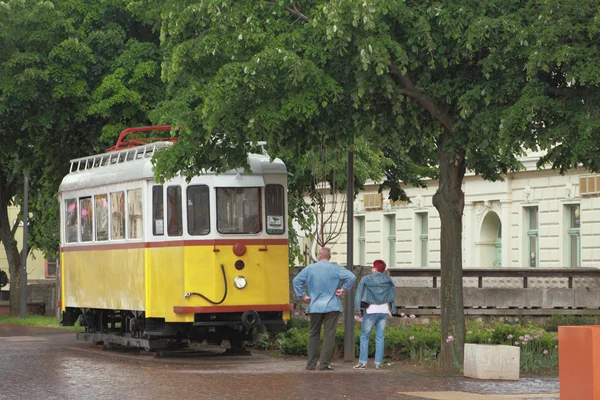 Ancient tram and man with woman, looking at him. Pecs, Hungary