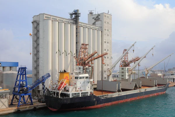 Elevator and bulk carrier with grain, seaport. Savona, Italy