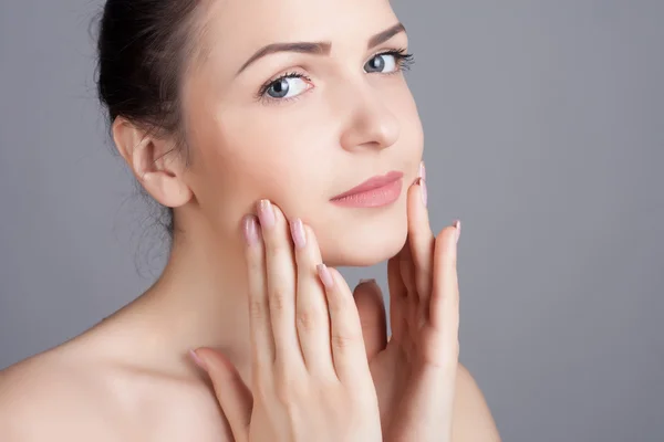 Close-up portrait of a beautiful young woman. Skin care concept. Natural look. Beauty portrait. Spa and health.