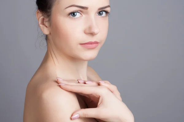 Close-up portrait of a beautiful young woman. Skin care concept. Natural look. Beauty portrait. Spa and health.