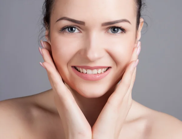 Close-up portrait of a beautiful young woman. Skin care concept. Natural look. Beauty portrait. Spa and health.