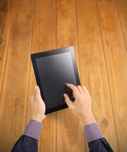 Hands holding and pointing on contemporary digital tablet