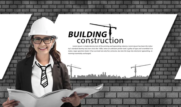 Happy asian female architect in protective helmet and blueprint with brick wall background