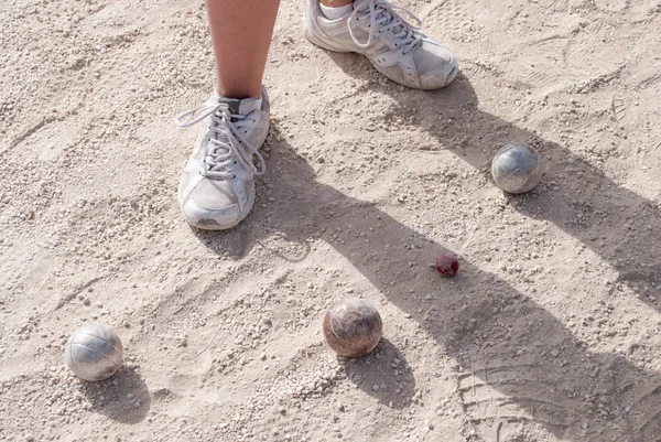 Human's foots in front of petanque balls