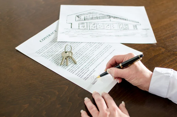 Woman signing a real estate contract