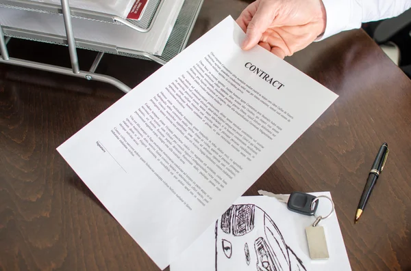Dealer showing a car purchase contract