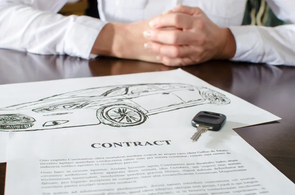 Female car buyer sitting in front of contract