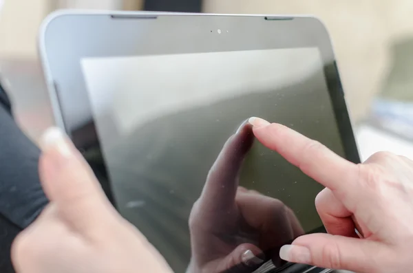 Finger touching screen of tablet computer