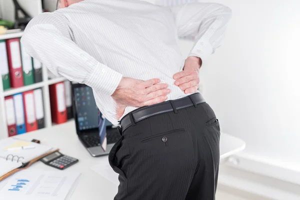 Businessman suffering from back pain