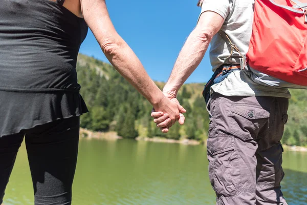 Couple on hike hand in hand