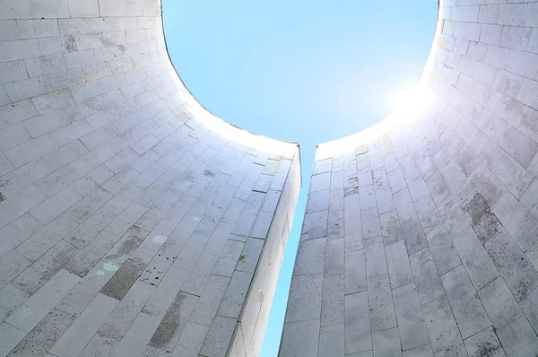 Bottom view of semicircular walls of minimalist urban design -architecture futuristic background with reflected sunlights.