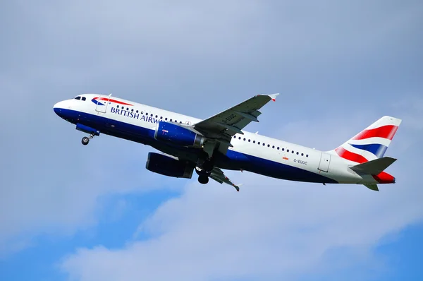 British Airways Airbus A320 aircraft is flying in the sky after departure from Pulkovo International airport in Saint-Petersburg, Russia