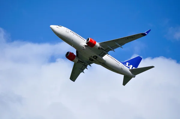 SAS Scandinavian Airlines System Boeing 737 Next Gen aircraft is flying in the sky after departure from Pulkovo International airport in Saint-Petersburg, Russia