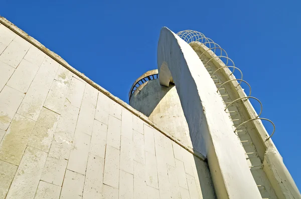 Perspective architecture bottom view of stairs made of concrete and rebar, leading up to the column built in futuristic urban style.