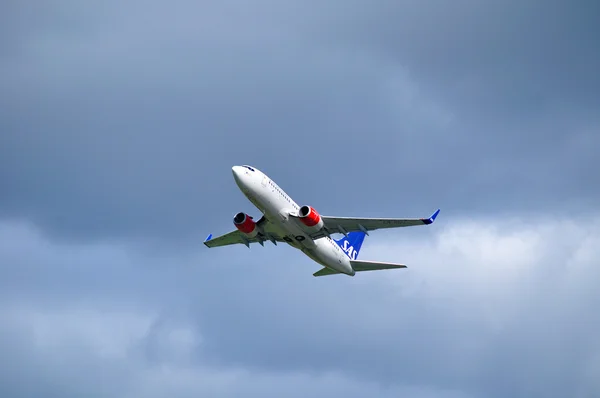 SAS Scandinavian Airlines System Boeing 737 Next Gen aircraft is flying in the sky after departure from Pulkovo International airport in Saint-Petersburg, Russia