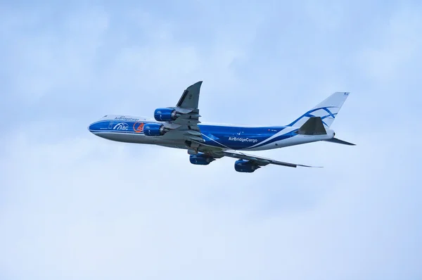 Air Bridge Cargo Airline Boeing 747 airplane is flying above after departure from Pulkovo International airport in Saint-Petersburg, Russia