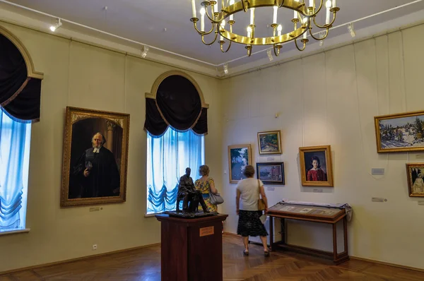 Interior of the Art Museum -unidentified museum visitors look pictures hanging on the walls in the Art Museum of Veliky Novgorod, Russia