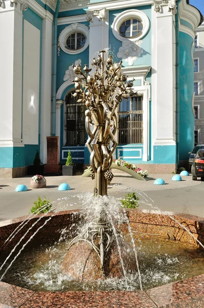 Small fountain in the shape of the pomegranate tree near Armenian Apostolic Orthodox Church of St. Catherine on Nevsky Prospect in Saint-Petersburg, Russia