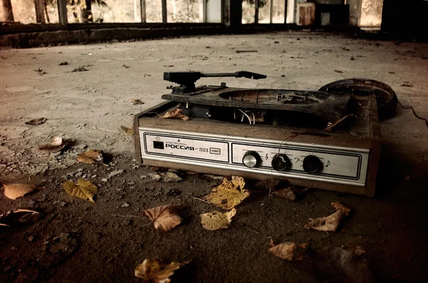 Industrial landscape - Old broken turntable among the yellowed leaves on the floor of abandoned building
