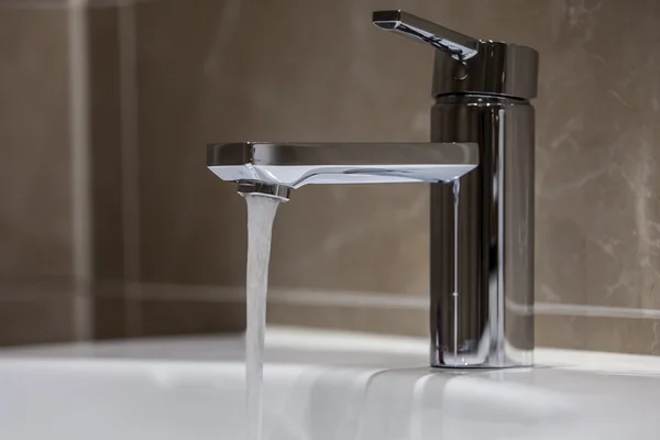 Water tap with flowing water