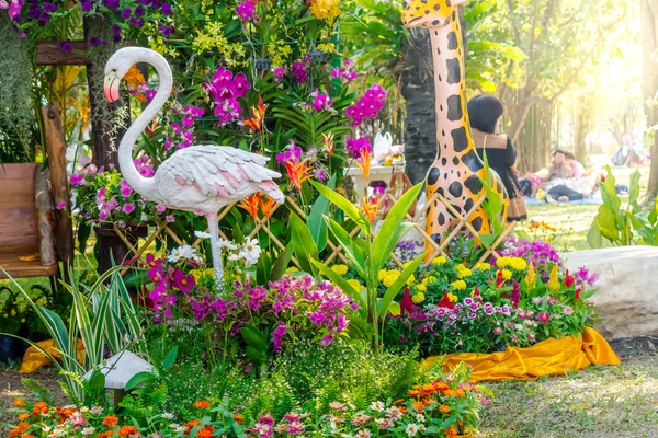 Flamingo  bird statue in flower garden.