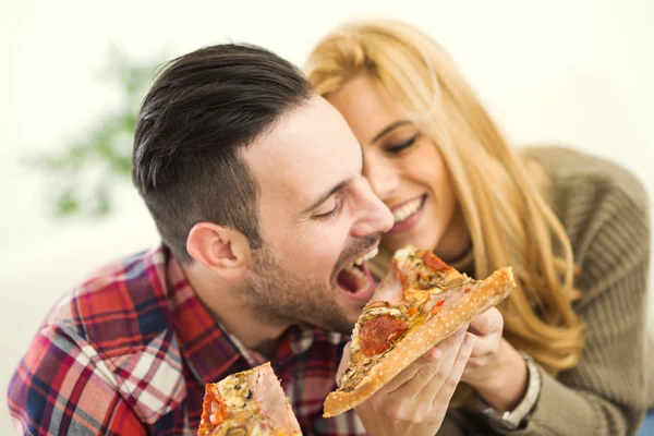 Couple eating pizza