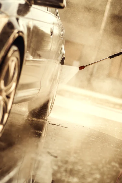 Cleaning the car with high pressure washer