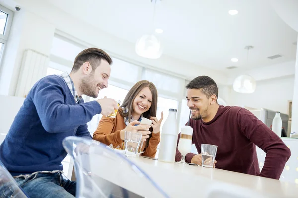 Happy young people having fun in a cafe