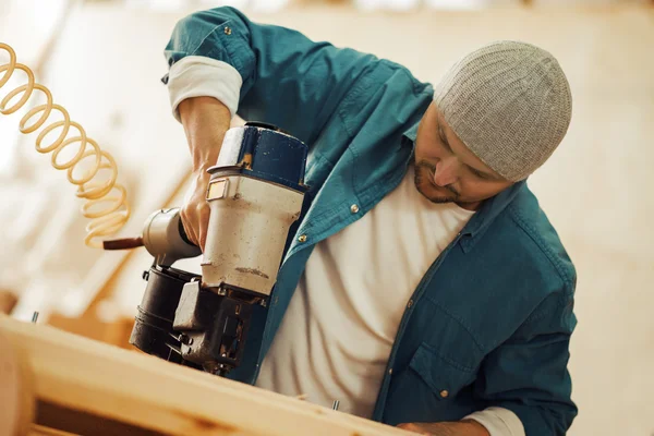 Safety-conscious contractor or homeowner working with nail gun