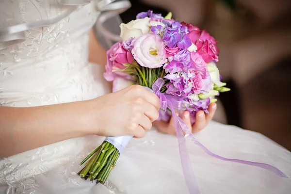 Wedding bouquet in the hands of  bride